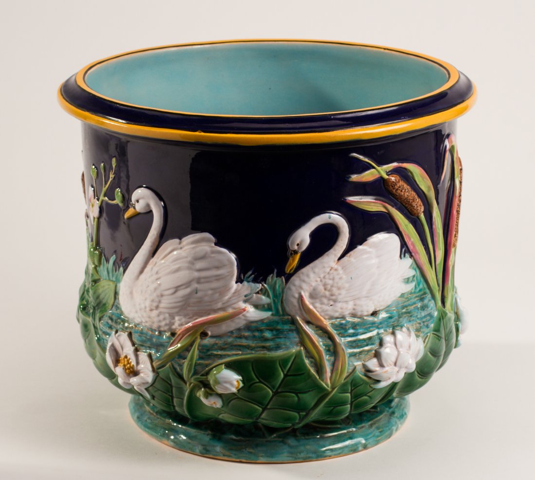 English 19C George Jones Majolica Swan 14" Jardiniere: English 19C George Jones Majolica Pottery Water Lily and Swan Jardiniere. The 19th century jardiniere is decorated with swans and cat tails all over the body. Impressed mark. In good condition. Measur
