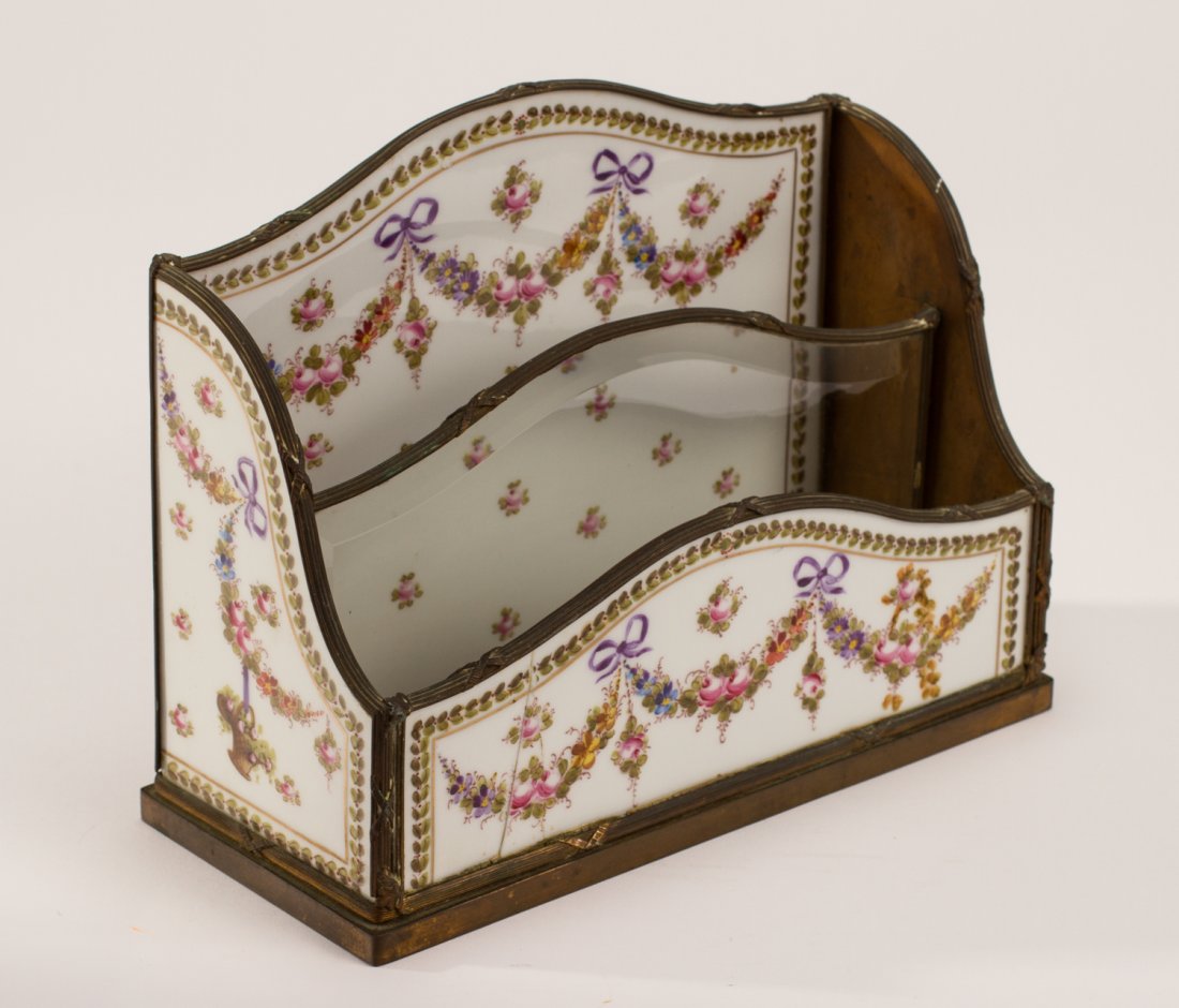 Ornate French 19C Porcelain Ormolu Mounted Letter Rack: French 19C Porcelain and Ormolu Mounted Letter Rack. The ornate 19th century porcelain rack has panels on the front and sides and a glass divider between the porcelain panels. The front panel has a sm