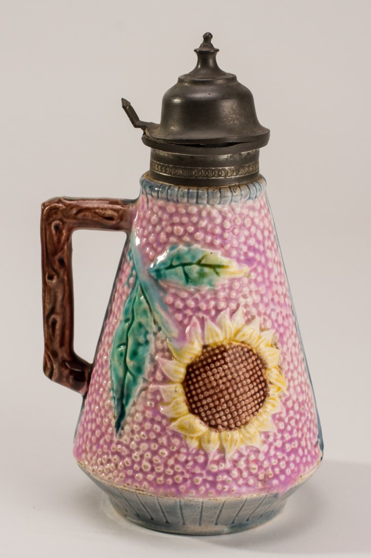 Etruscan Majolica Pottery Sunflower Syrup: Etruscan 19C Majolica Sunflower Syrup. Majolica pottery syrup pitcher made by Griffen, Smith & Co, in the Etruscan pattern. Last quarter of 19th century. Light purple ground with sunflower and attache