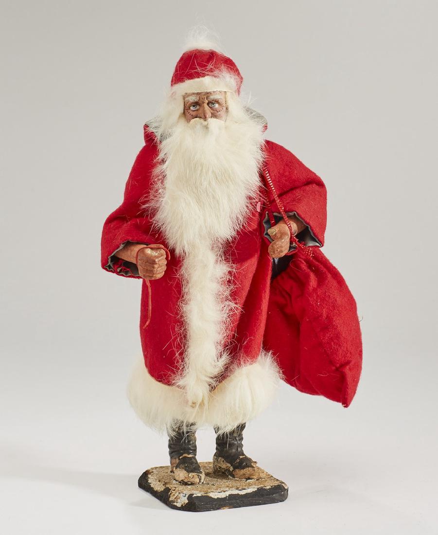 German 19C Belsnickel Santa Claus Toy Candy Container: German 19C Belsnickel Toy Santa Claus Candy Container. The early two piece 19th century paper mache and composition Christmas Candy container has a stern German traditional St. Nicholas face. The figu