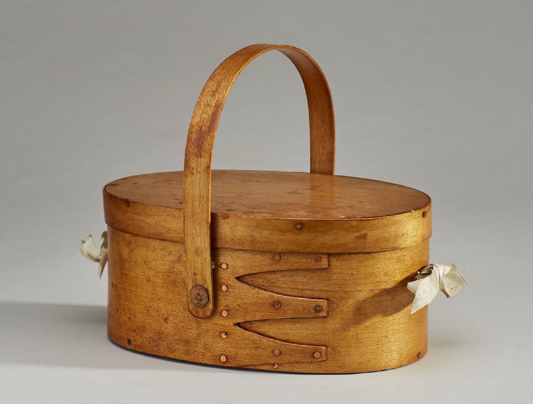 Shaker 19C Oval Handled Sewing Box Carrier: Shaker 19C Oval Handled Sewing Box Carrier. The 19th century shaker oval sewing box retains the original silk interior with pincushion, strawberry needle sharpener, woven needle case and thread. The e