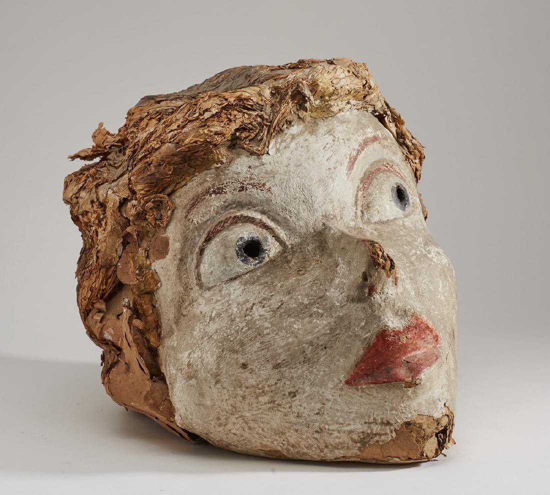 Old Papier Mache Early 20C Mardi Gras Head Mask: Old Papier mache early 20C Mardi Gras Head Mask. The early 20th century painted head has layered paper hair and depicts a young woman. There are two eyeholes and the mask rests on the shoulders when w