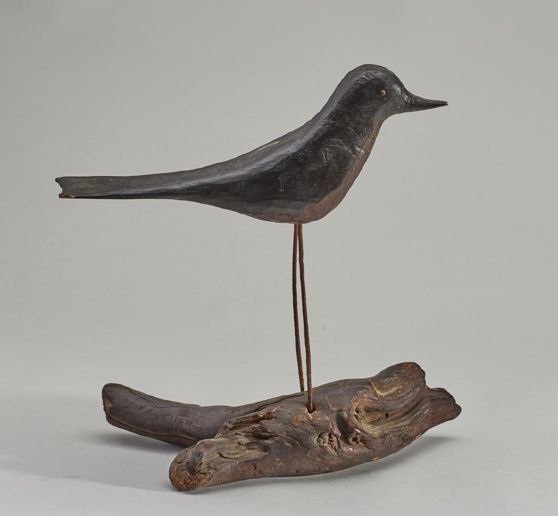 Carved and Painted Folk Art Figure of Black Bird: Carved and Painted Folk Art Figure of a Black Bird. The old folk art bird is mounted on a piece of driftwood with wire legs. In good condition. Measures 11 inches high. Notes: Thank you for your bid! 