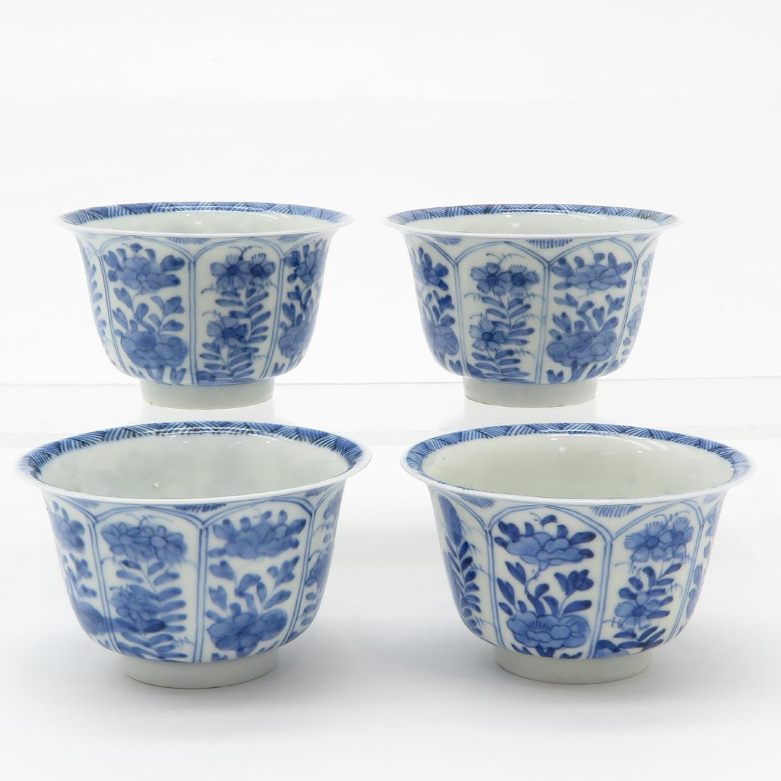 Lot of 4 Cups: 4 blue and white decor cups, marked on the bottom, 8 cm. in diameter.