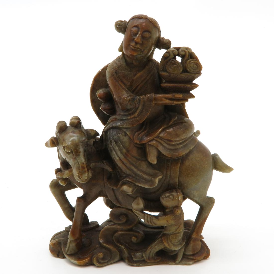 Soapstone Sculpture: Depicting man on horse holding basket, 19 cm. tall, chip.