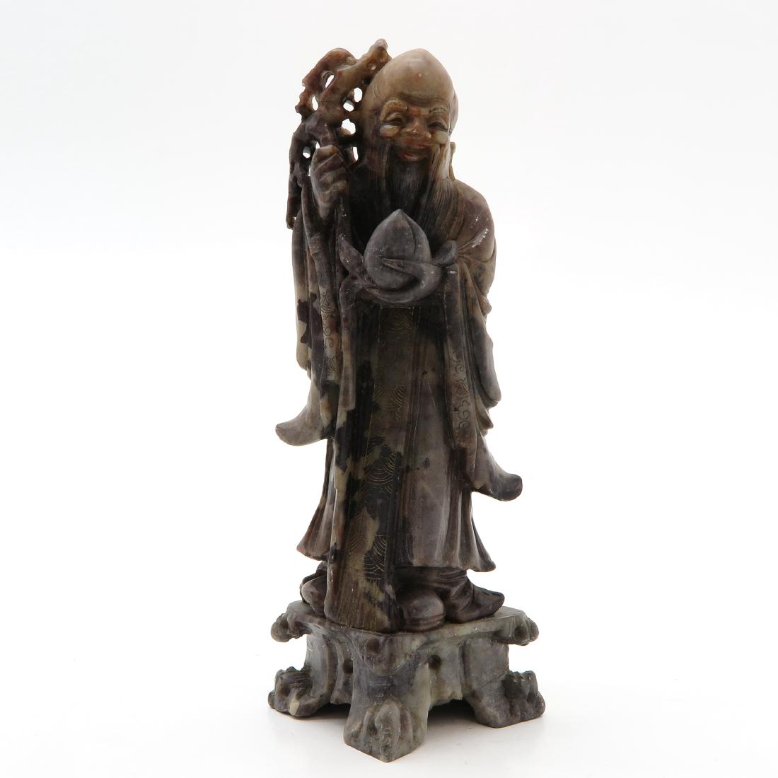 Soapstone Sculpture: Depicting wise man with fruit and staff, 21 cm. tall.