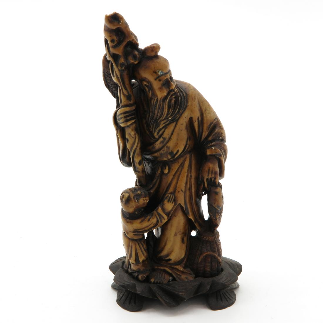 Soapstone Sculpture: Depicting man with child and staff, 18 cm. tall.