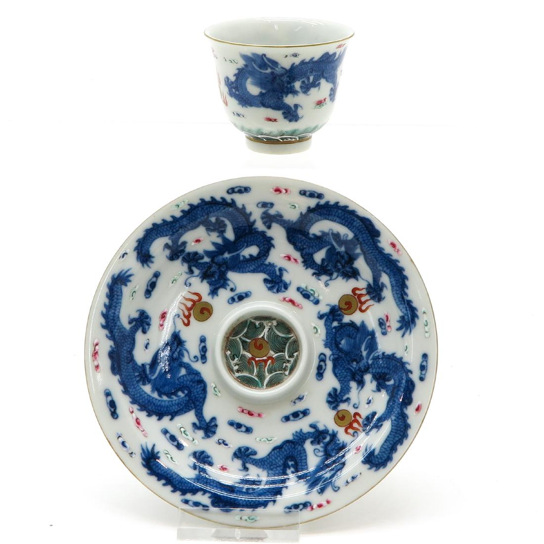 Cup & Saucer: China, fitted cup, very detailed blue dragon decor, marked with Qianlong seal mark, saucer is 12 cm. in diameter.