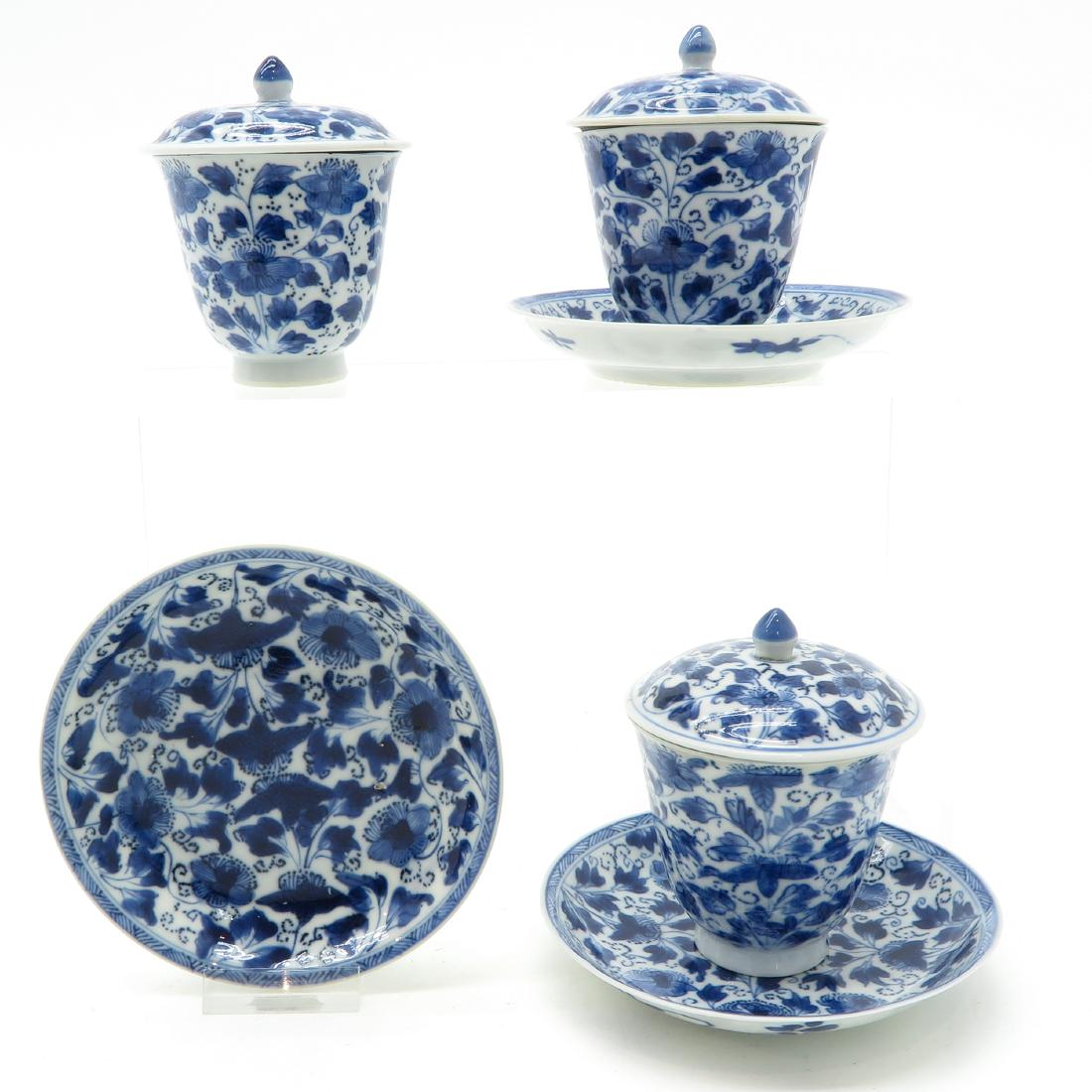 Lot of Lidded Cups & Saucers: Including 3 lidded cups and saucers, blue and white decor, 12 cm. in diameter, chip and hairline.