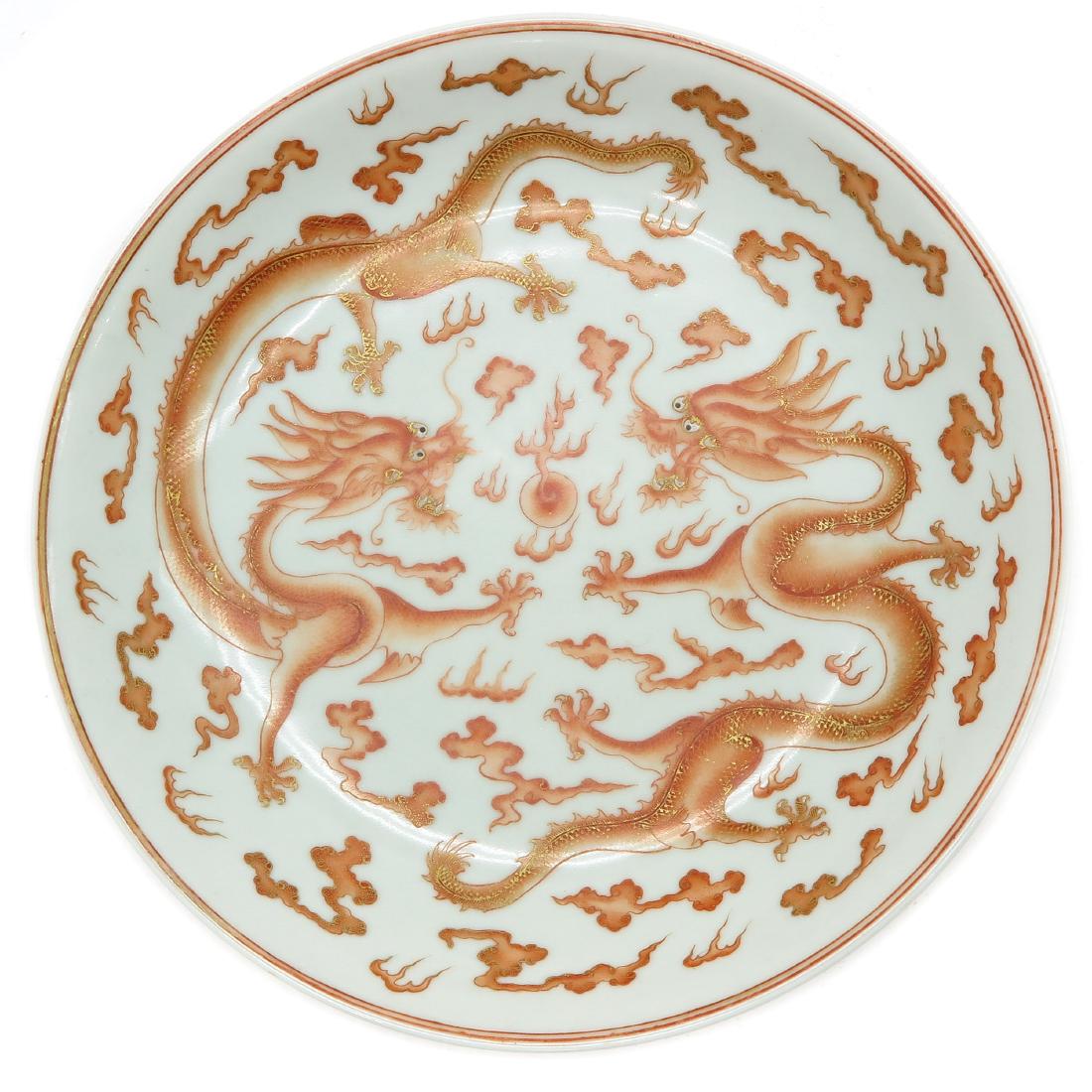 Plate: Orange decor of 5 claw dragon and clouds, marked with seal mark on the bottom, 22 cm. in diameter.