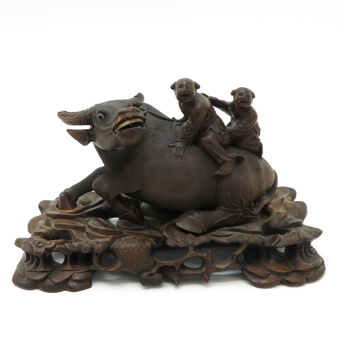 Carved Wood Sculpture: Depicting children riding ox, 22 cm. tall, chip on mouth.