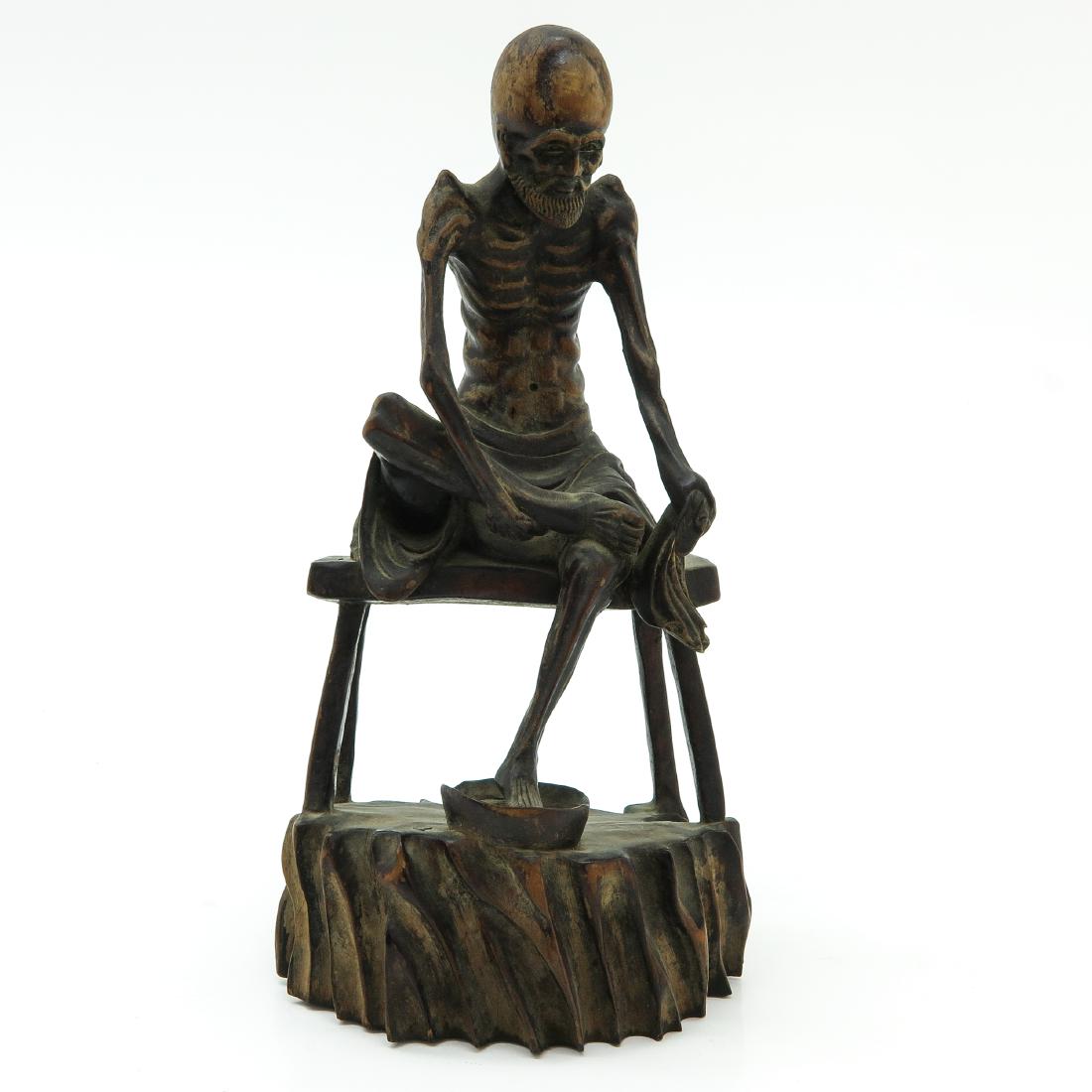 A Carved Wood Sculpture: Depicting man with beard washing feet, 27 cm. tall.