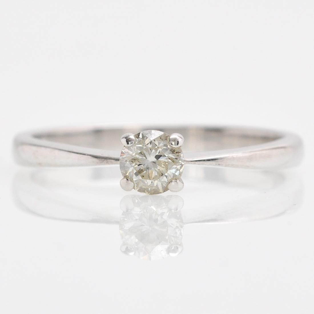 An 18KWG Ladies Solitaire Diamond Ring: Approximately 0.25 carat, ring size 16.5.