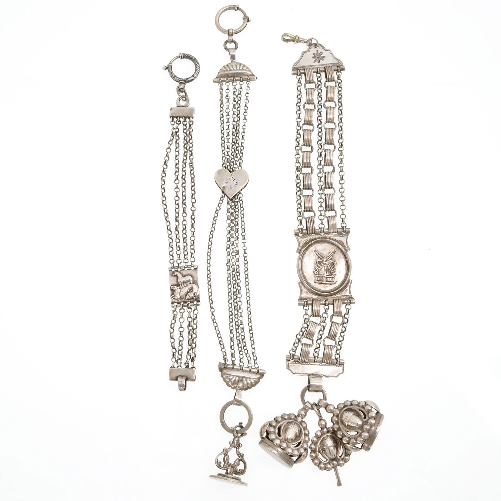 A Collection Dutch Silver Chatelaines: Including one with signet and watch keys, 27 cm long.