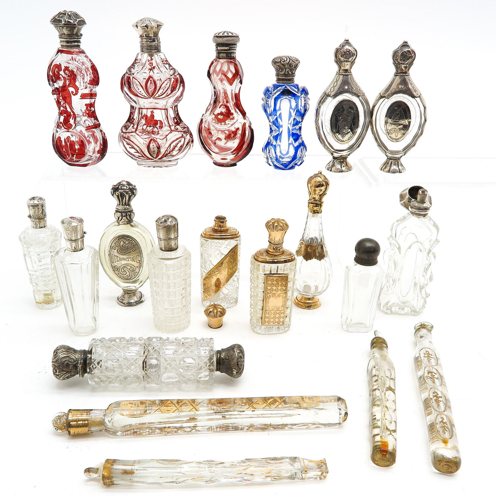 A Collection of 19th Century Perfume Bottles: trimmed with silver and gold