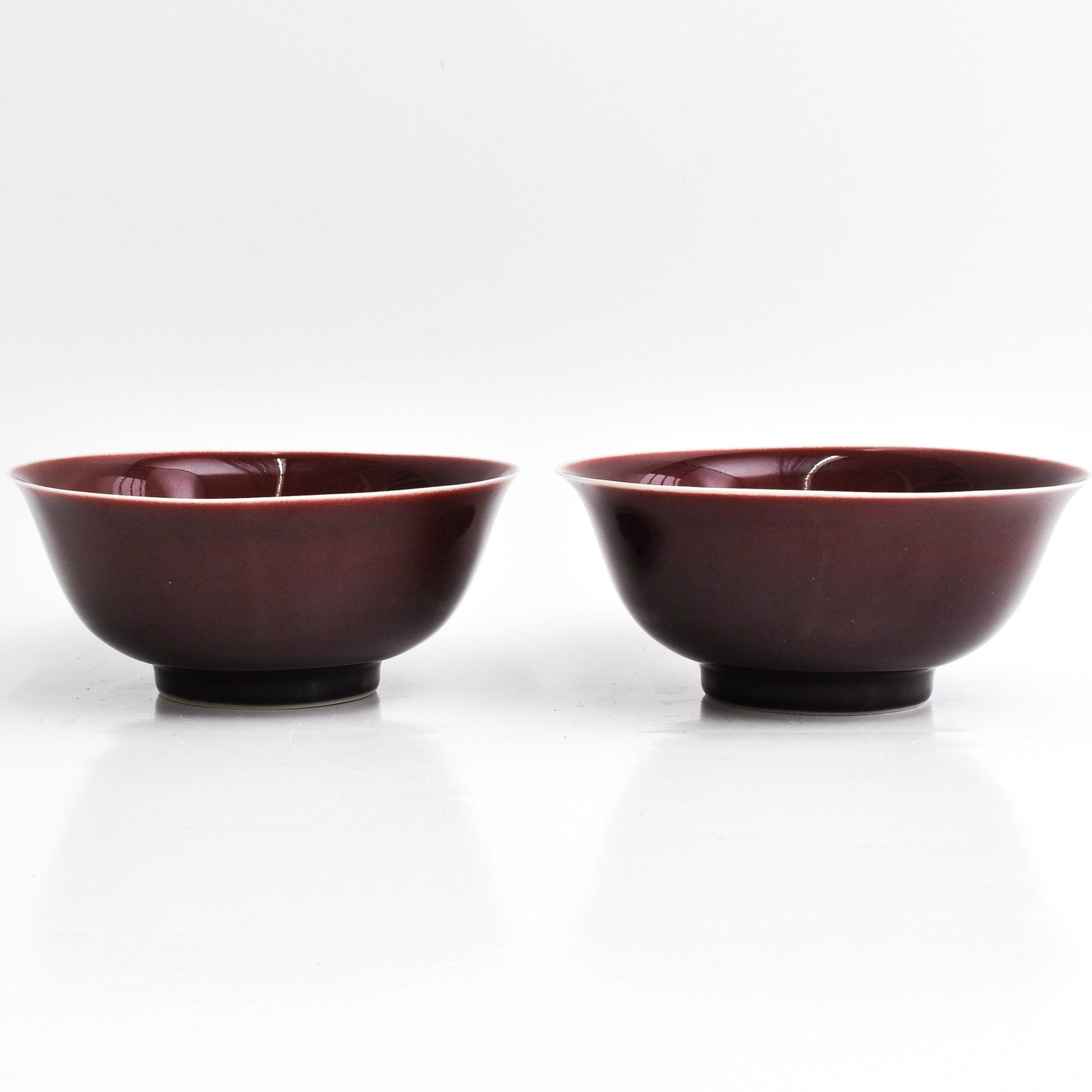Two Chinese Ox Blood Bowls: On raised circular, 16 cm. in diameter, ware in bottom of one bowl.