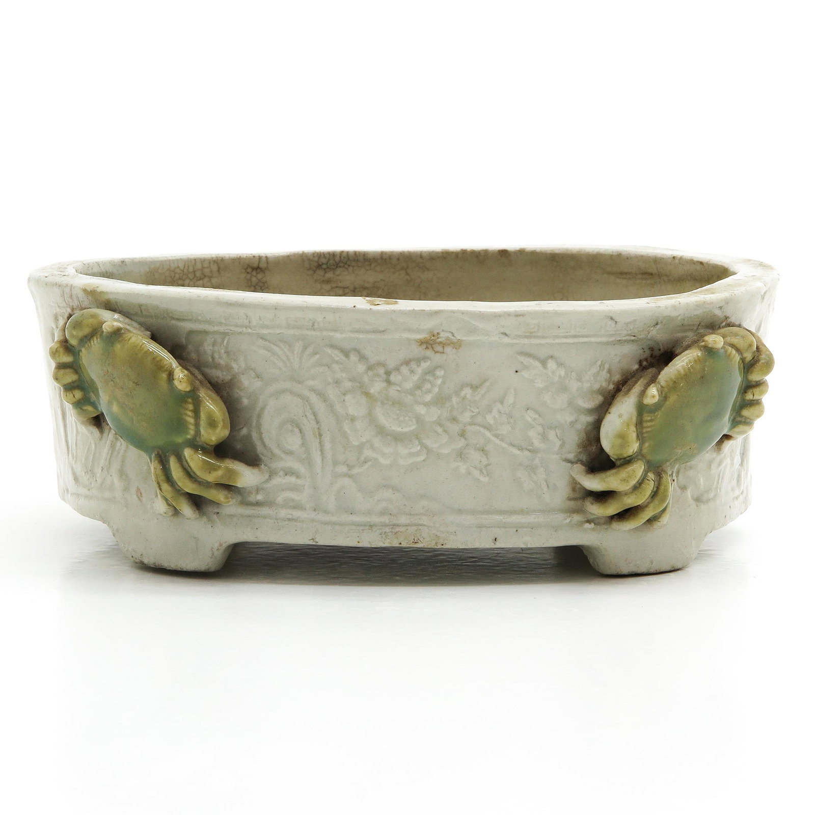 A Chinese Jardinaire: Floral decor with two celadon crabs, remnants of wax seal remaining on bottom, 17 cm. long.