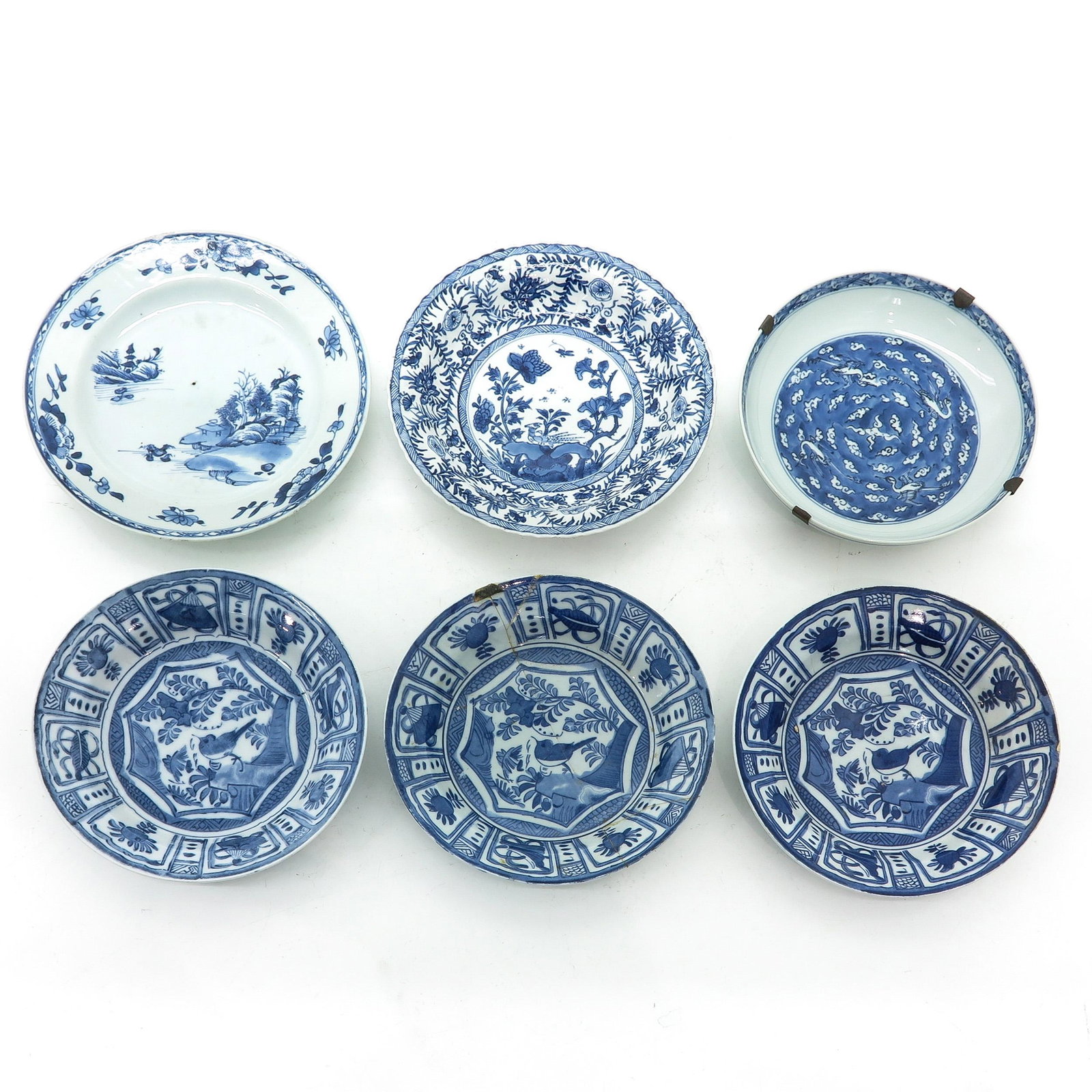 A Collection of 6 Blue and White Plates: In diverse decors and sizes, including Kangxi Mark and Period, largest plate is 23 cm. in diameter, in diverse conditions.