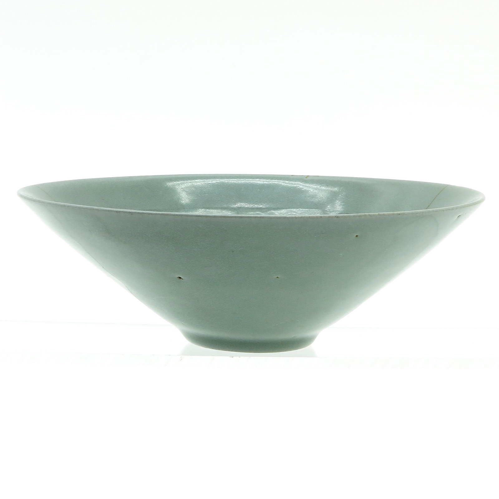 A Korean Celadon Glaze Bowl: Decorated with floral decor in sgraffito, 17 cm. in diameter, hairline.