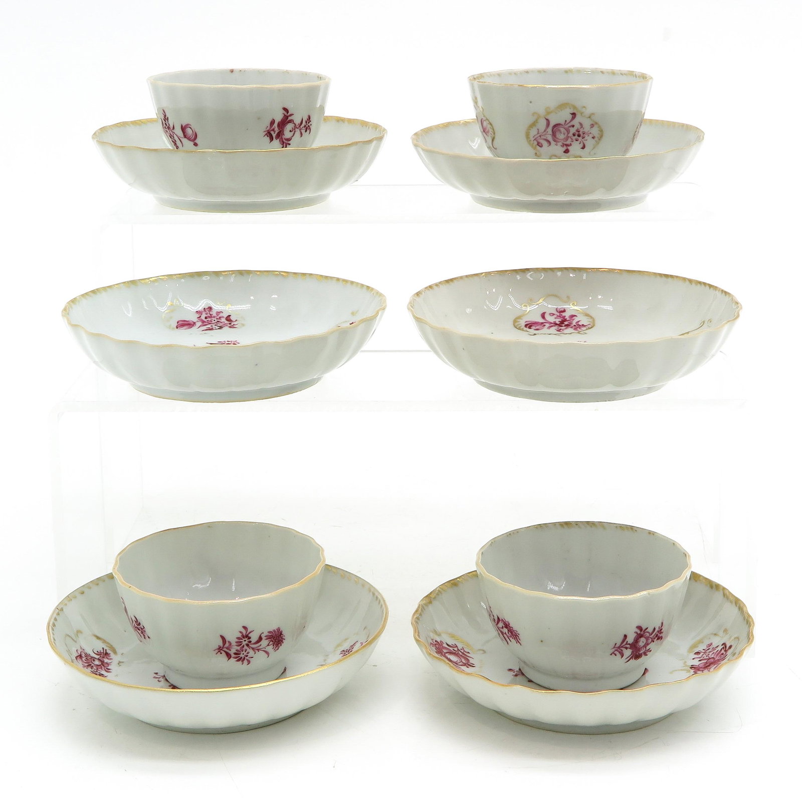 A Collection of Cups and Saucers: Including 4 cups and 6 saucers, 18th Century, in pink floral decor, 12 cm. in diameter, hairline in glaze.