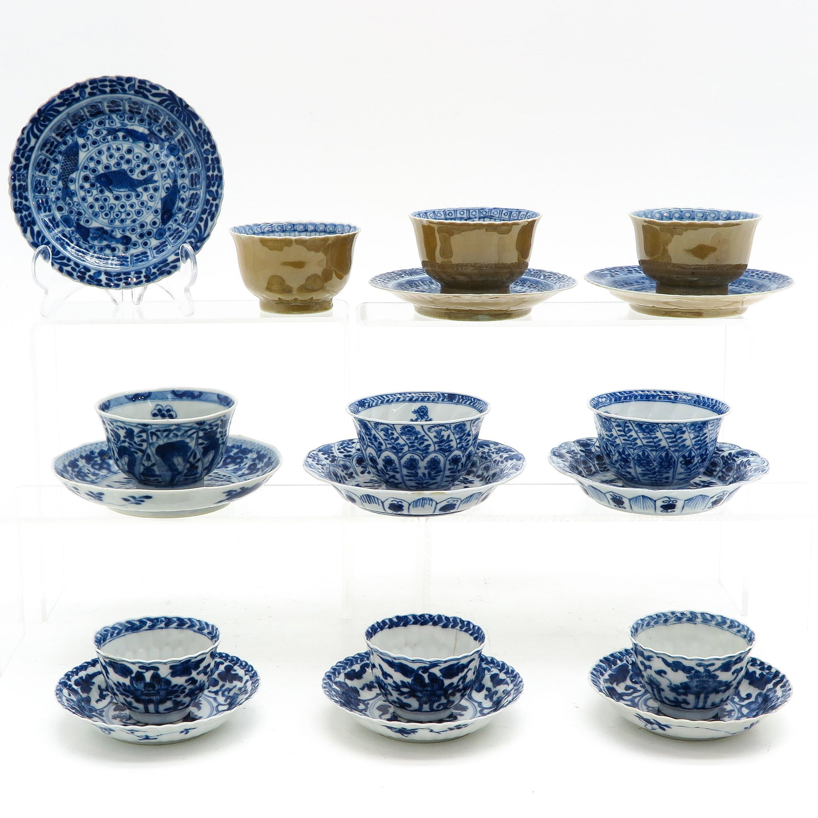 A Collection of Cups and Saucers: Including 9 cups and saucers, largest saucer is 14 cm. in diameter, including Kangxi Mark and Period, chip and hairline.