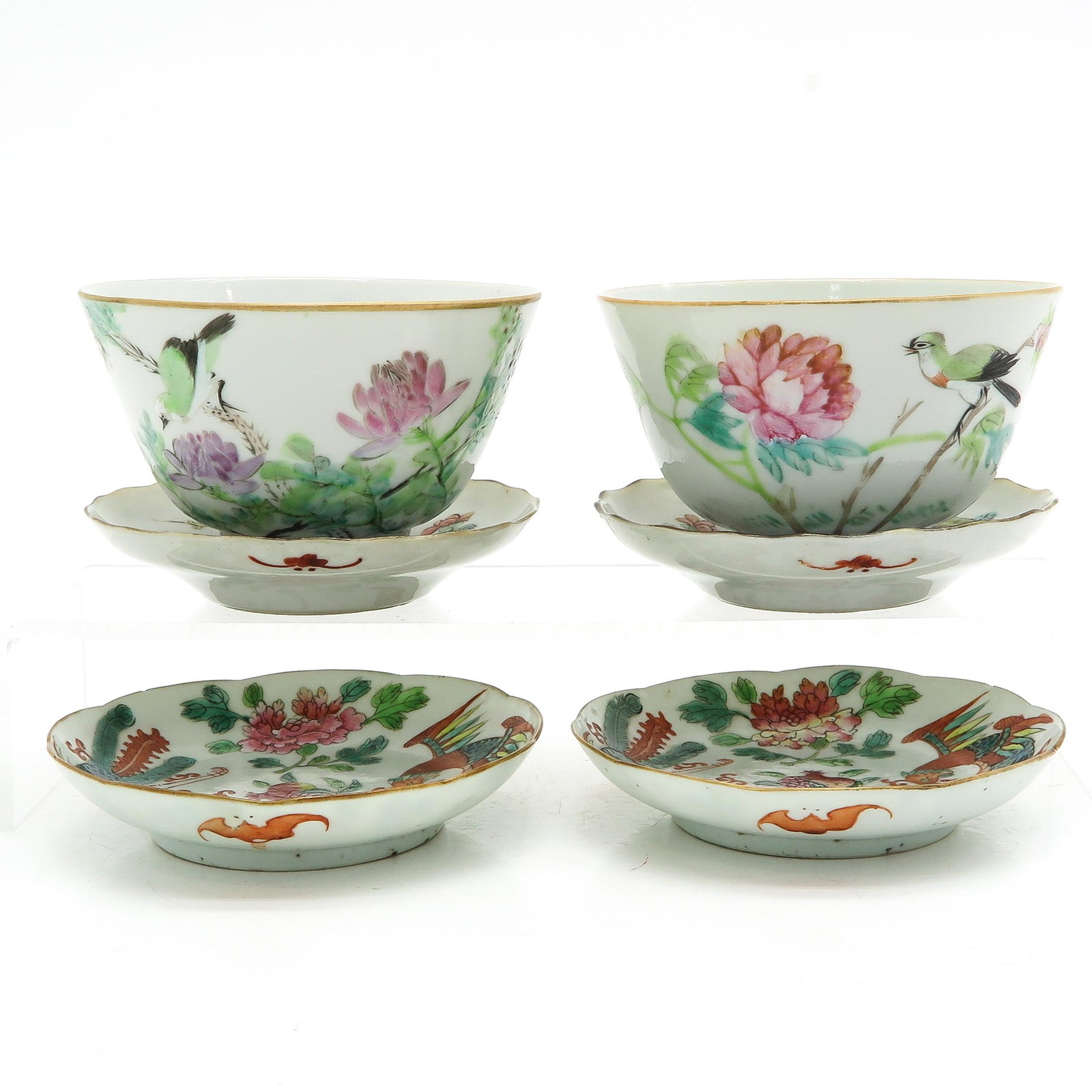 A Collection of Cups and Saucers: Including 2 cups and 4 saucers, in diverse polychrome decors, 19th Century, largest saucer 11 cm., fritting on edges.