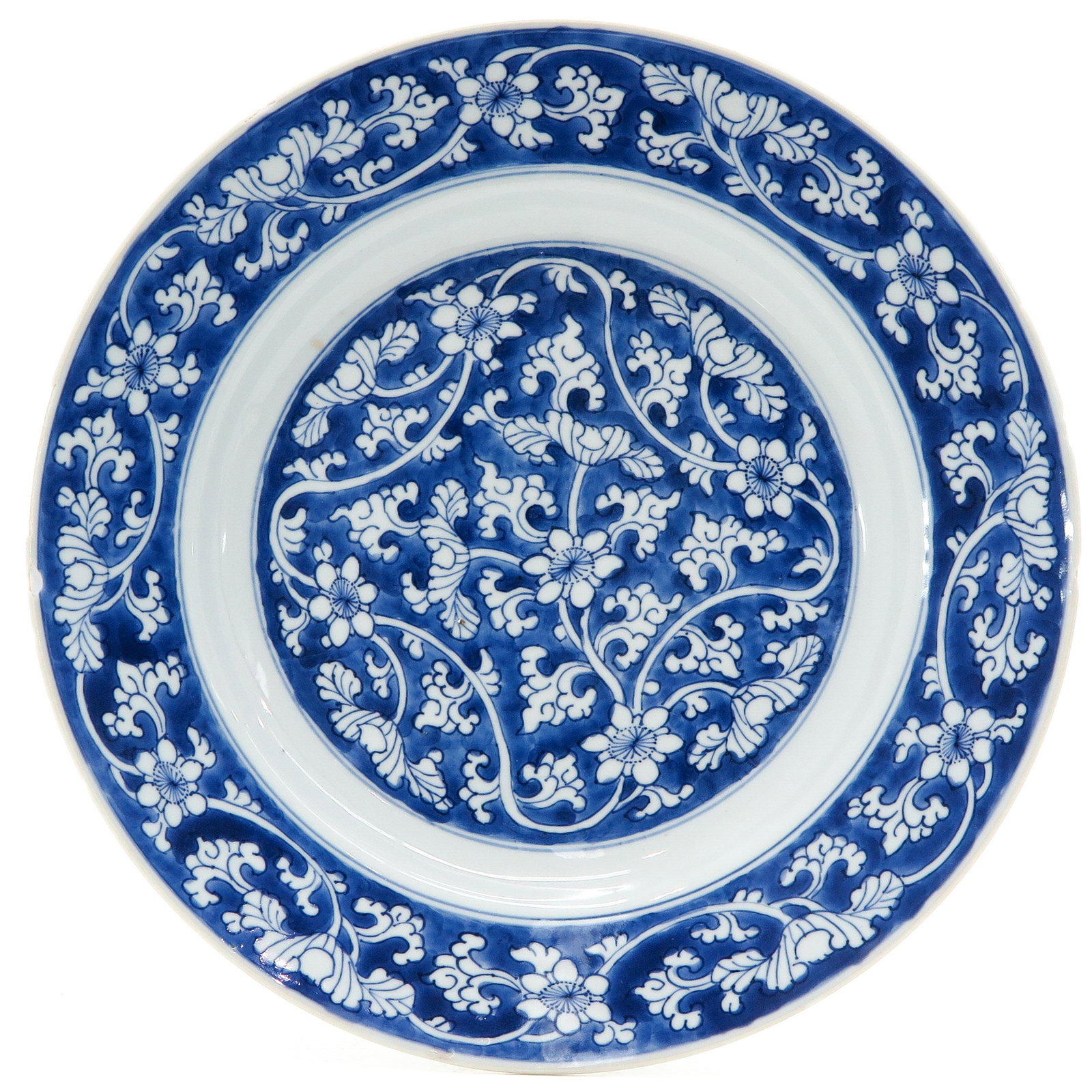 A Blue and White Plate: Floral decor, marked with double ring and artemisia leaf, 28 cm. in diameter, chips on edge.