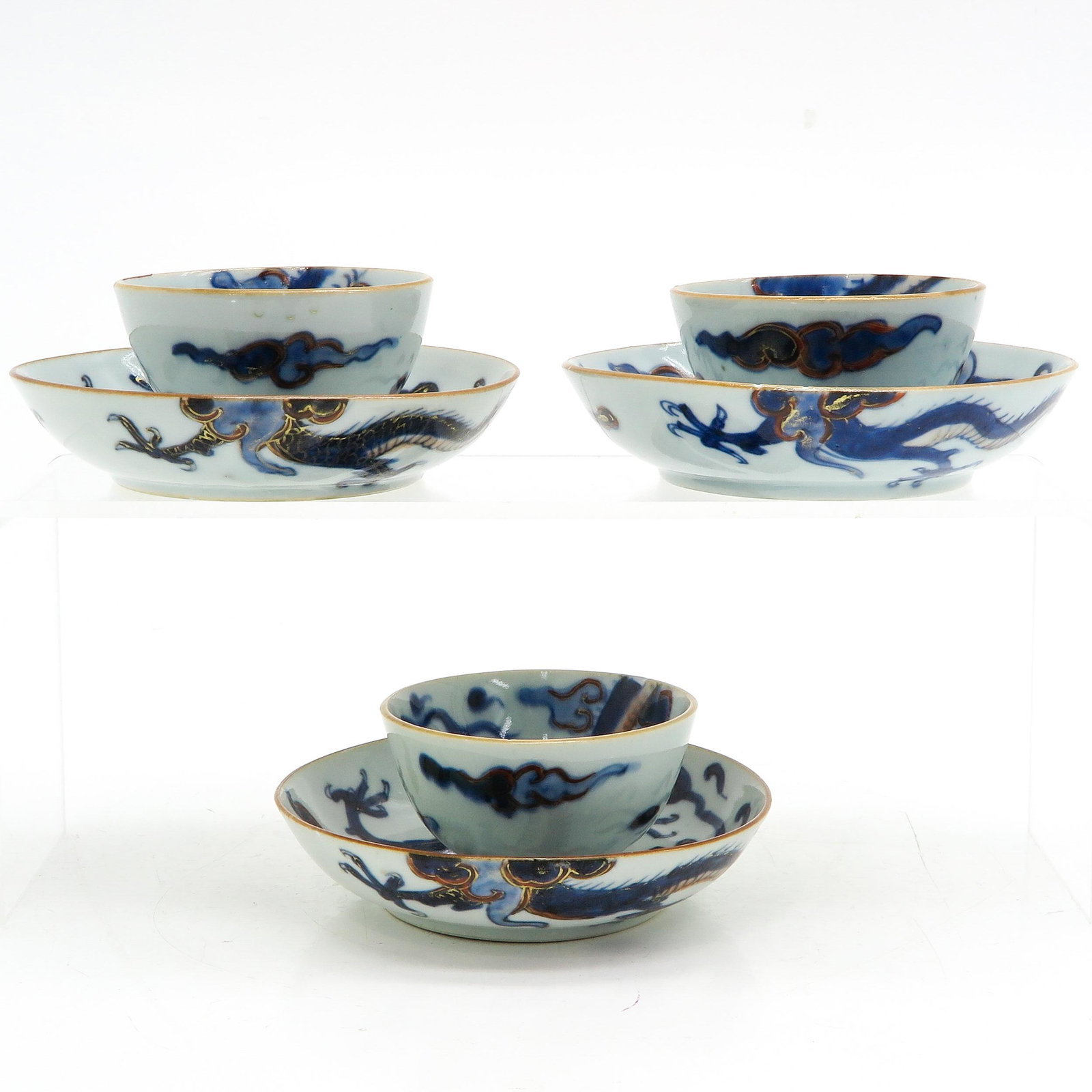 Three Blue and White Cups and Saucers: Dragon and cloud decor, 12 cm. in diameter, chip and hairline.
