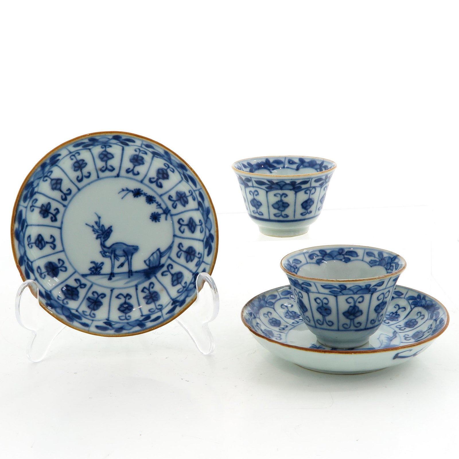 A Collection of Cups and Saucers: Including 2 cups and saucers, blue and white deer decor, saucers are 11 cm. in diameter, 18th Century, chip.