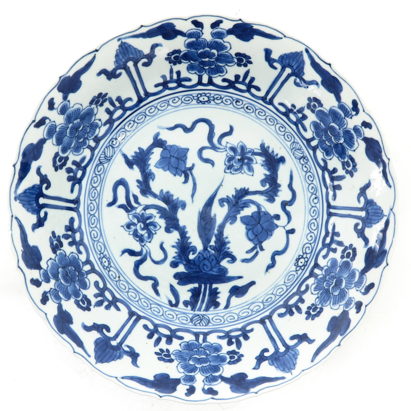 A Blue and White Plate: Floral decor, marked with double ring, 27 cm. in diameter, chip.