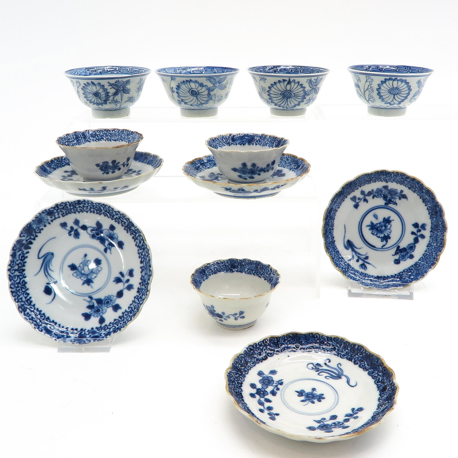 A Collection of Cups and Saucers: Blue and white floral decor, saucers are 12 cm. in diameter, chip and hairline.