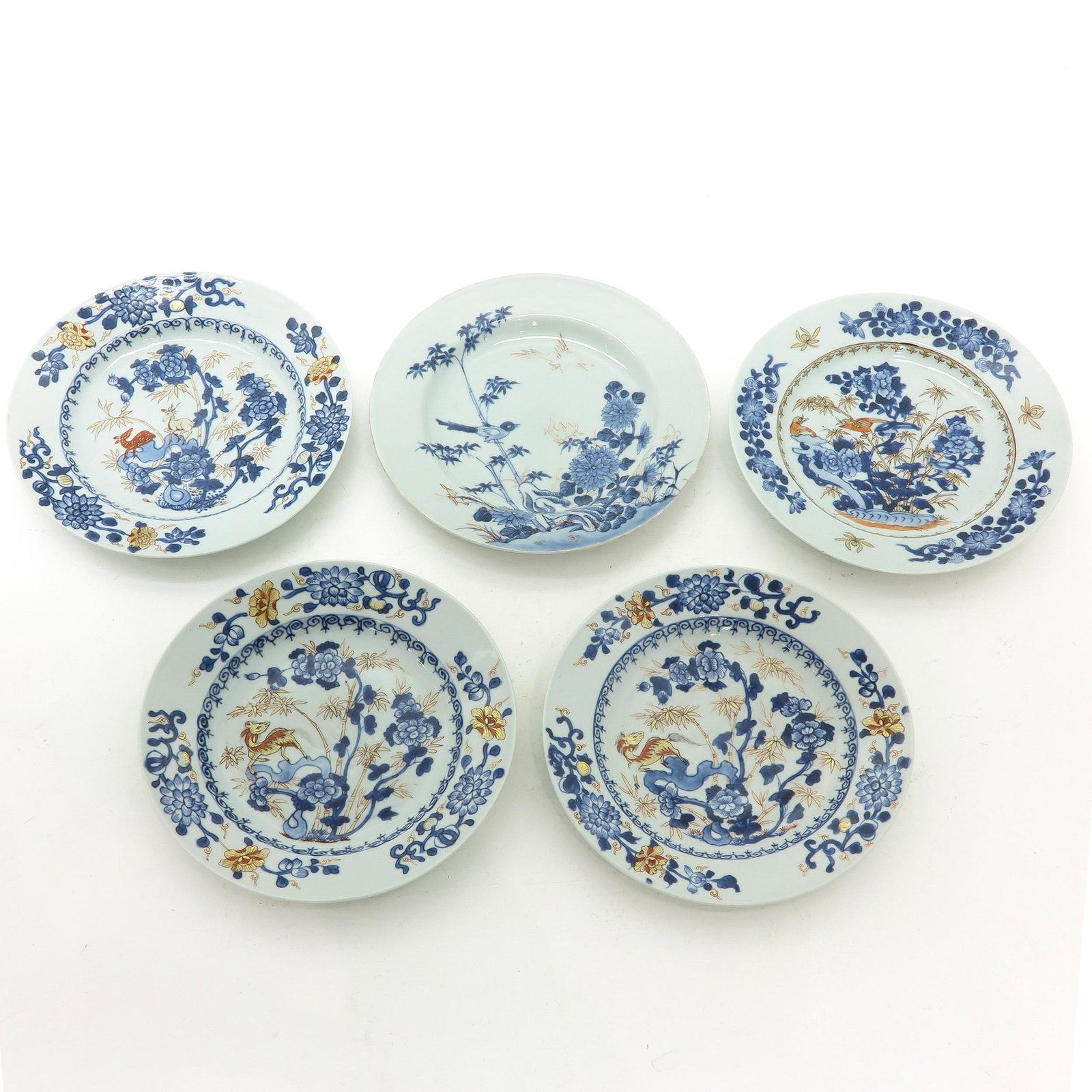 A Series of 5 Plates: Blue and iron red with gilt accents depicting garden scene with bamboo and birds, 23 cm. in diameter, chip and hairline.
