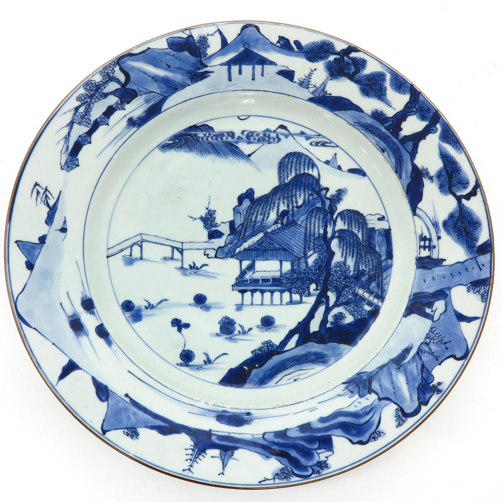 A Blue and White Charger: Landscape decor, marked with double ring on bottom, 18th Century, 41 cm. in diameter, chip and hairline.