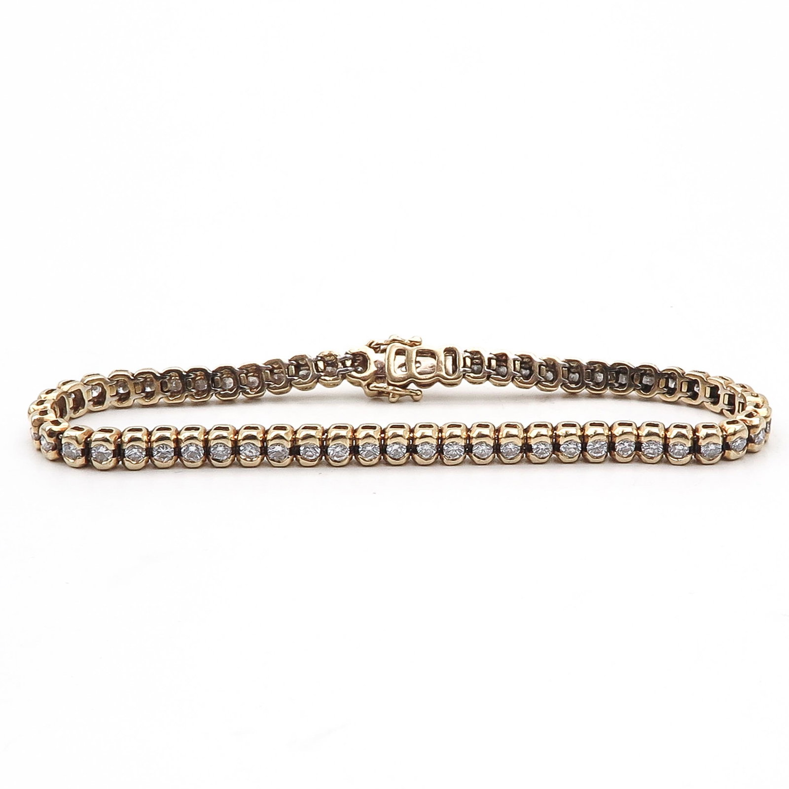 A Diamond Tennis Bracelet: Set with 58 brilliant cut diamonds, set in 18 KG, length 175 mm, weight 16 grams