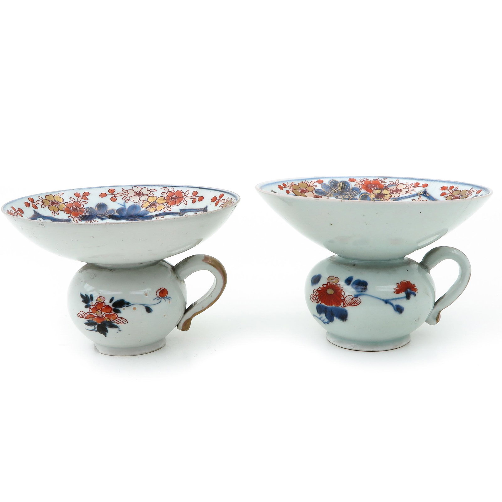 A Pair of Imari Spittoons: Iron red and blue floral deccor with gilt accents, 11 cm. tall x 17 cm. in diameter, chip and hairline.