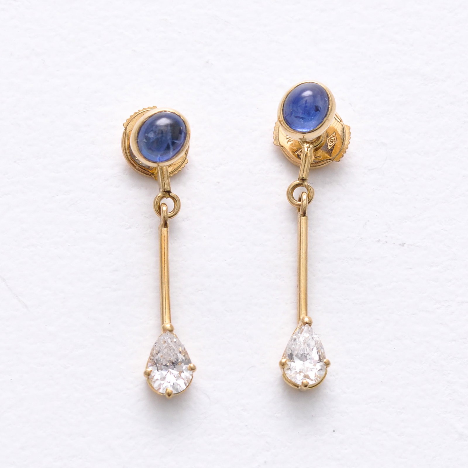 A Pair of 14KG Diamond Earrings: Pear shaped diamonds, approximately 5.7 x 4.3 mm.