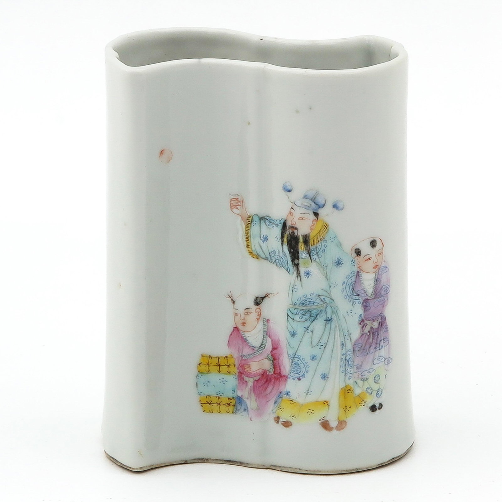 A Famille Rose Brush Pot: Decorated with Chinese figures, Christies sticker still remainiing, 12 cm. tall.