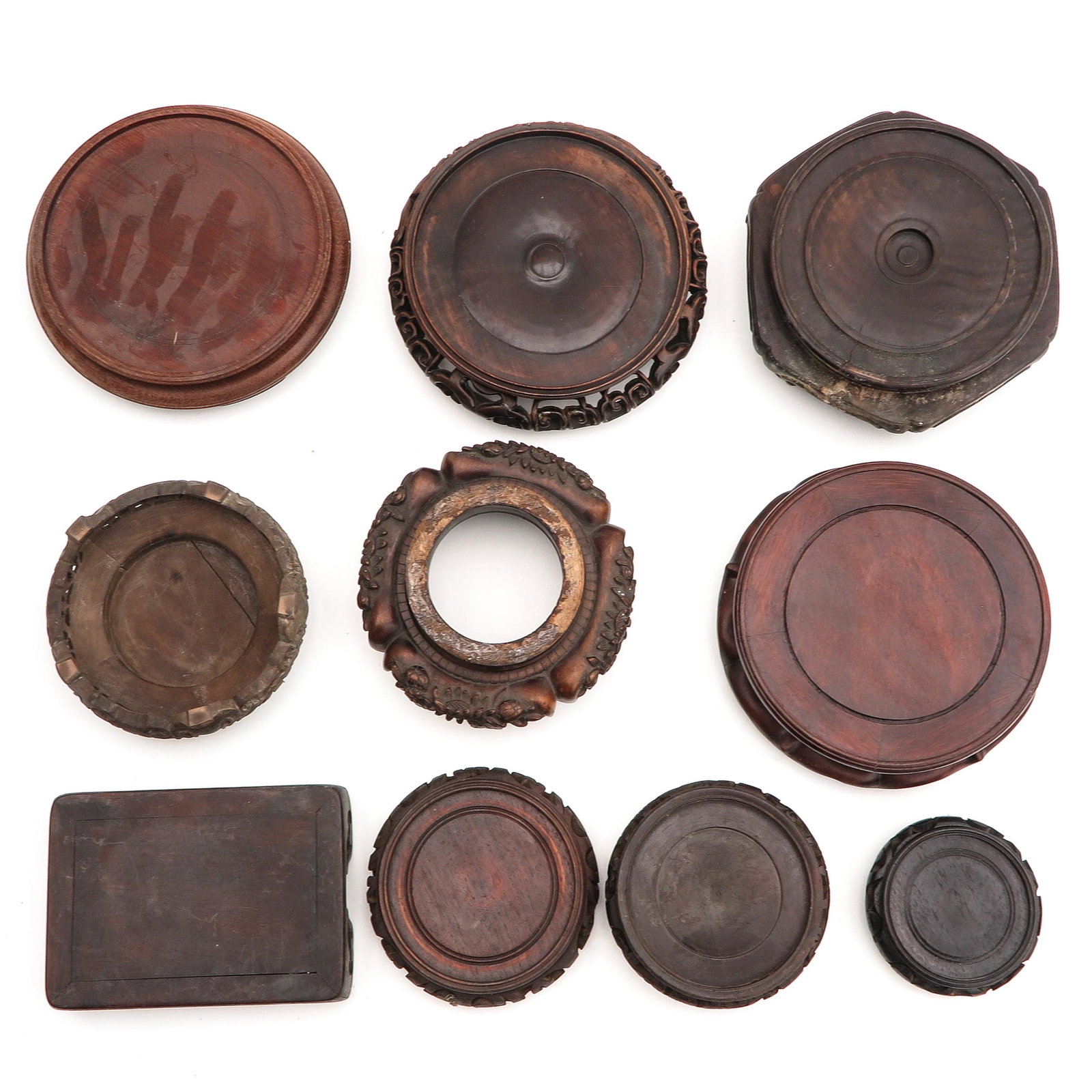 A Collection of Carved Wood Stands: In diverse sizes and decors.