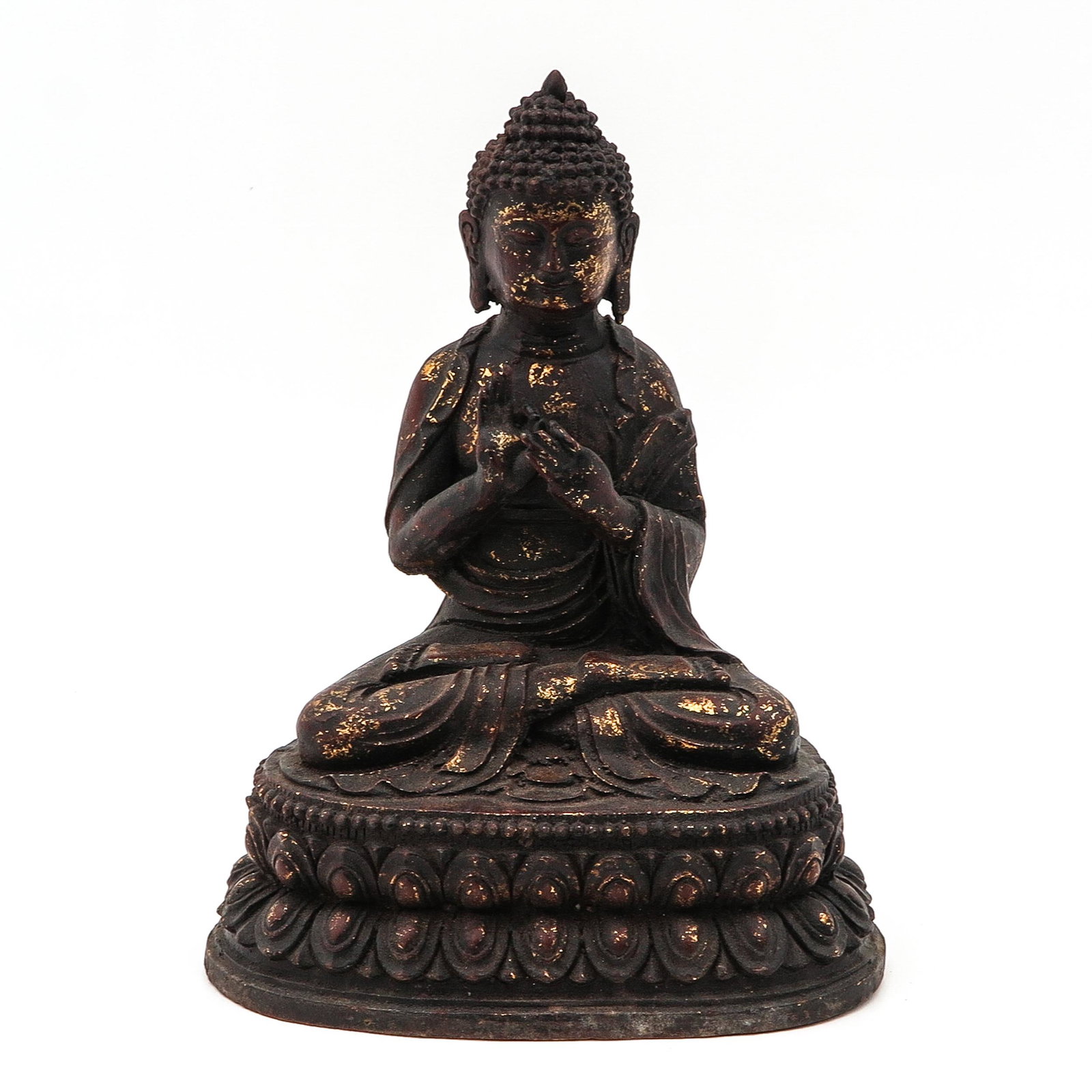 A Bronze Buddha Sculpture: Remnants of gilt paint remaining, 30 cm. tall.