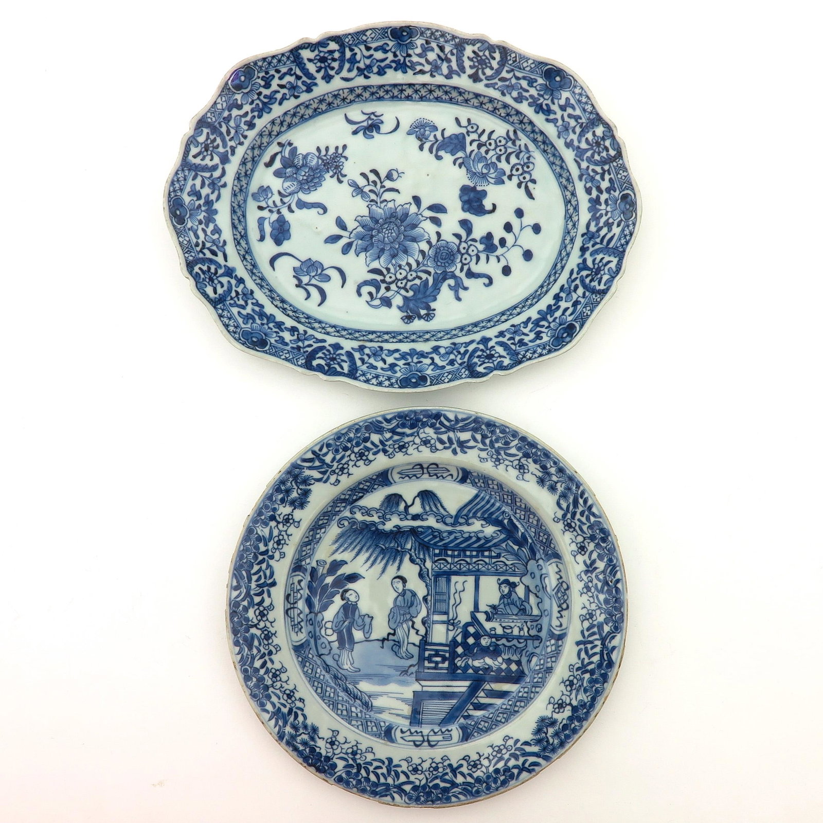 A Serving Tray and Plate: Blue and white floral decor on tray in addition to scene with Chinese figures, tray is 27 cm. long, chip.