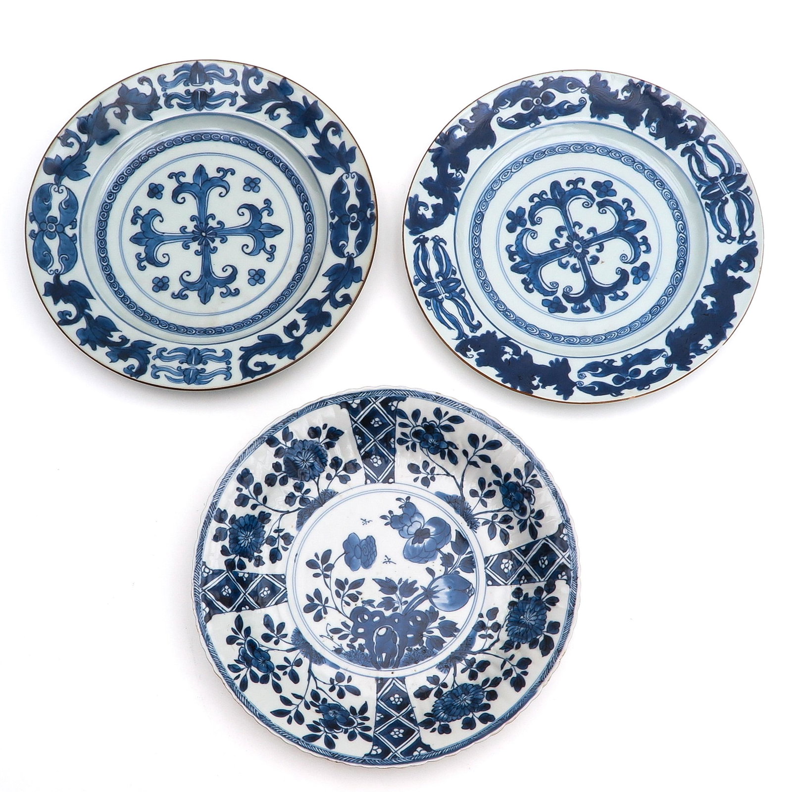 A Collection of 3 Blue and White Plates: Diverse blue and white decors, largest plate is 28 cm. in diameter, chip.