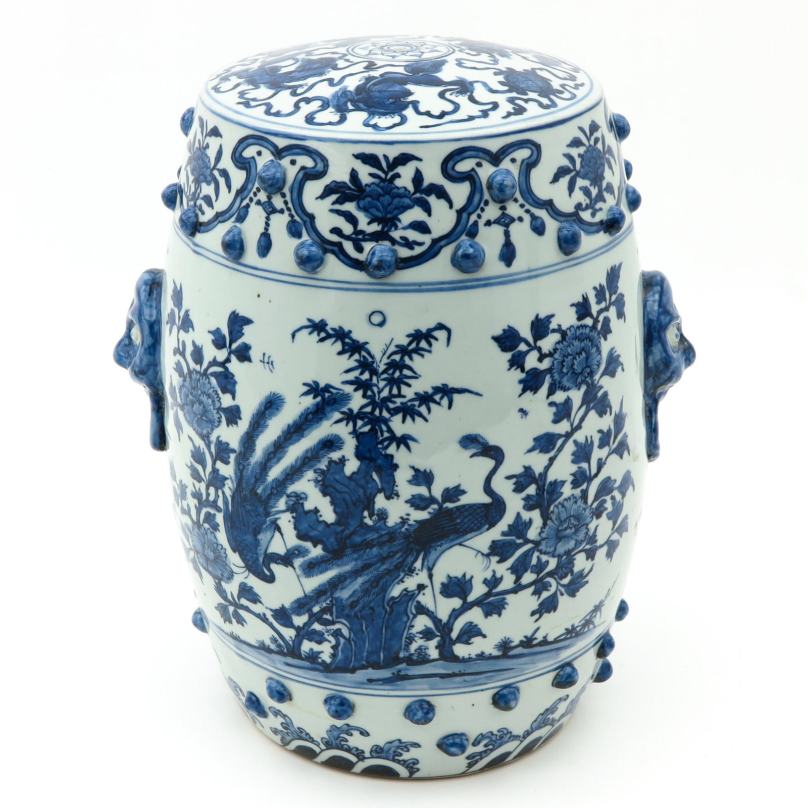 A Blue and White Garden Seat: Depicting scene in garden with flowers and birds, mask and ring handles, 42 cm. tall.