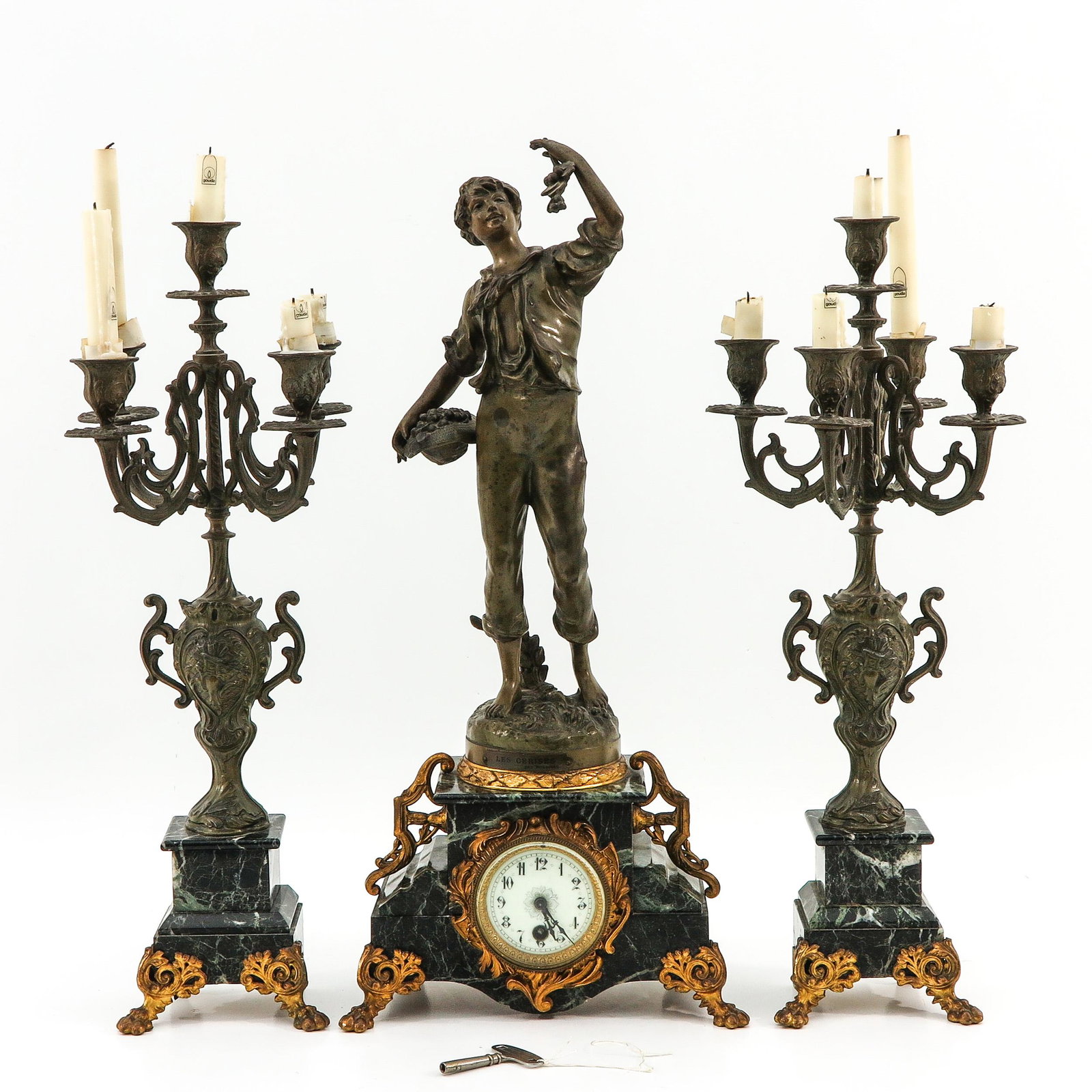 Clock set: copper with marble base, consisting of 2 candlesticks, height 57 cm. and clock, signed Rousseau, height 62 cm.,