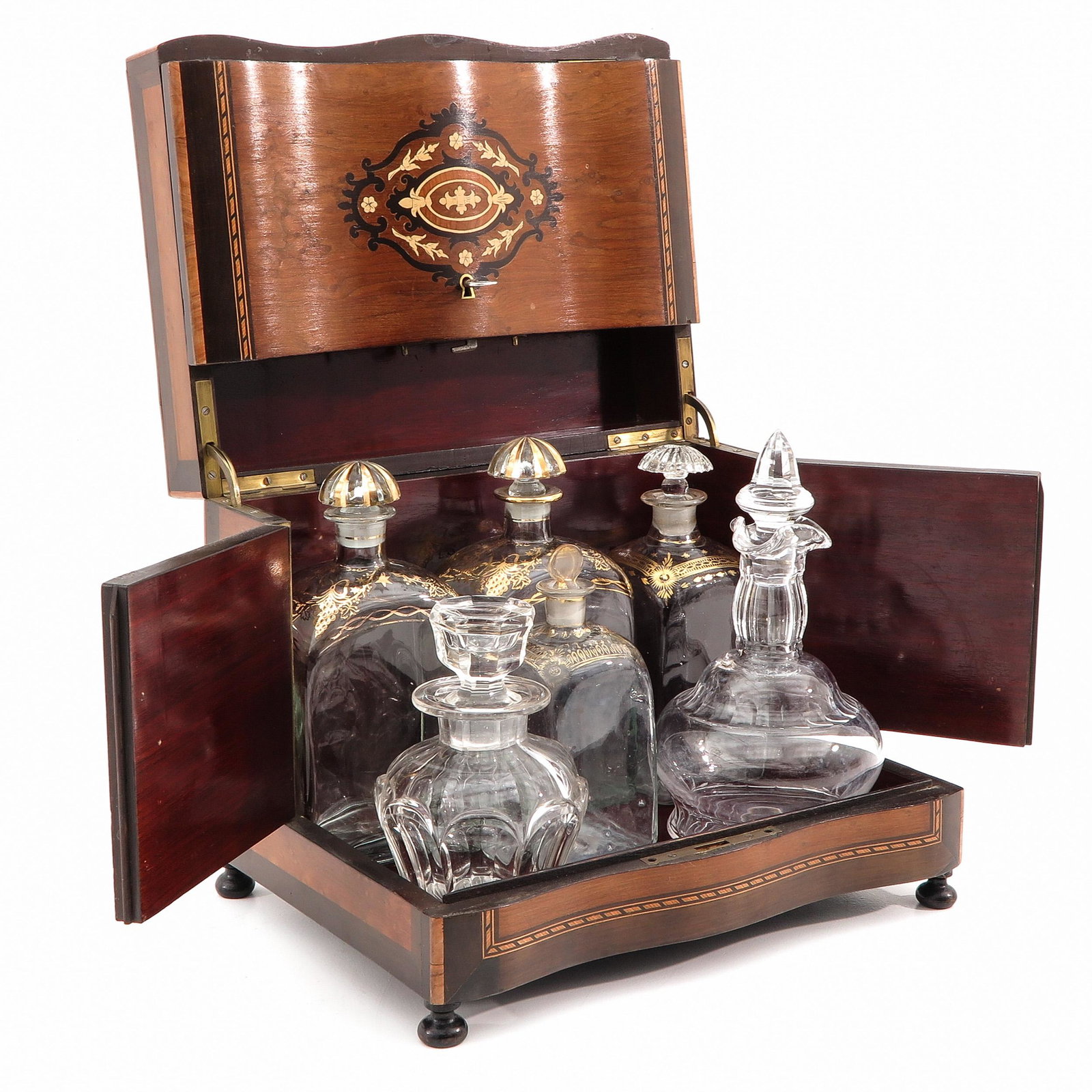 A Liquor Cellar: 19th century, inlaid with various types of wood, height 27 cm.