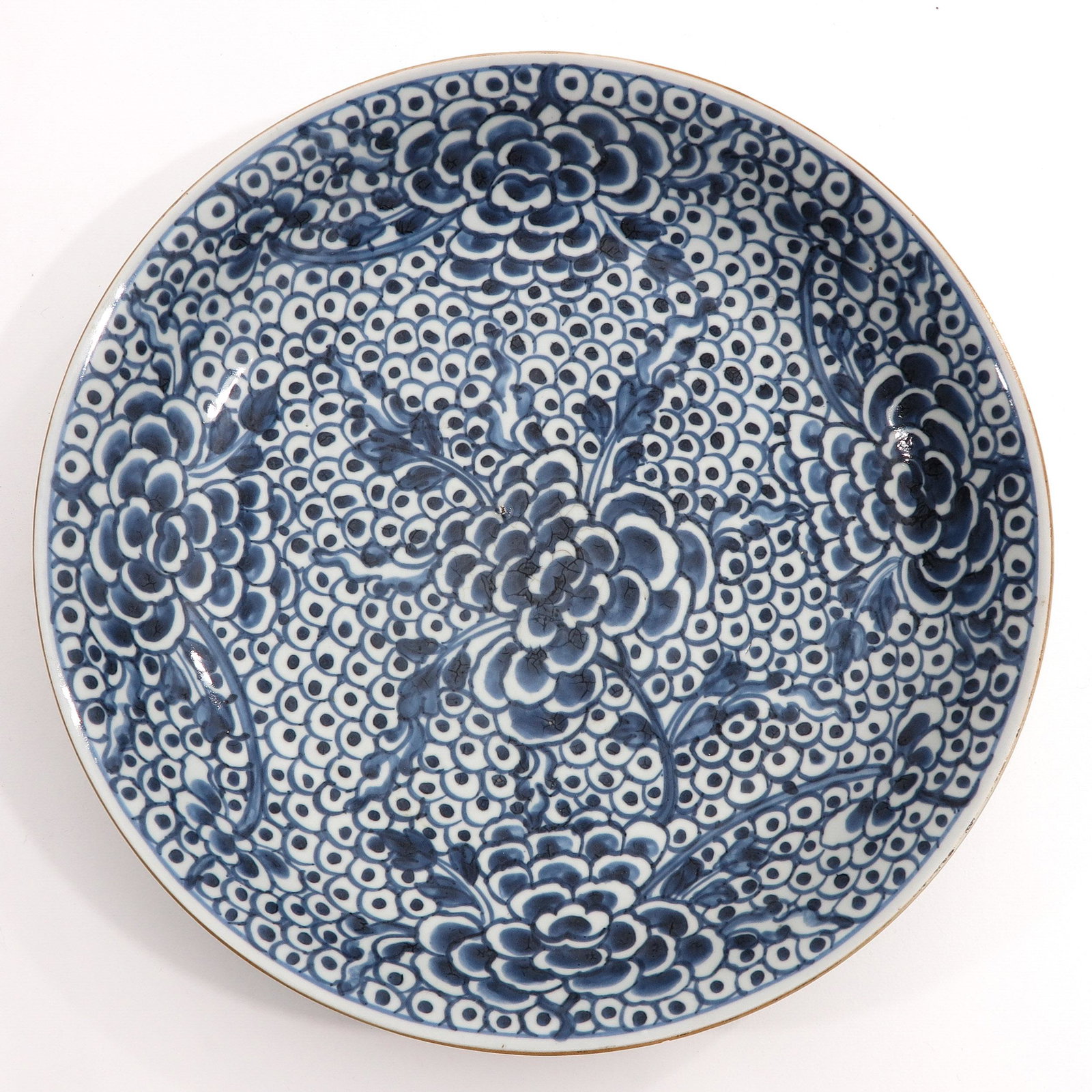 A Blue and White Charger: Decorated with flowers and grapes, 37 cm. in diameter, chip.