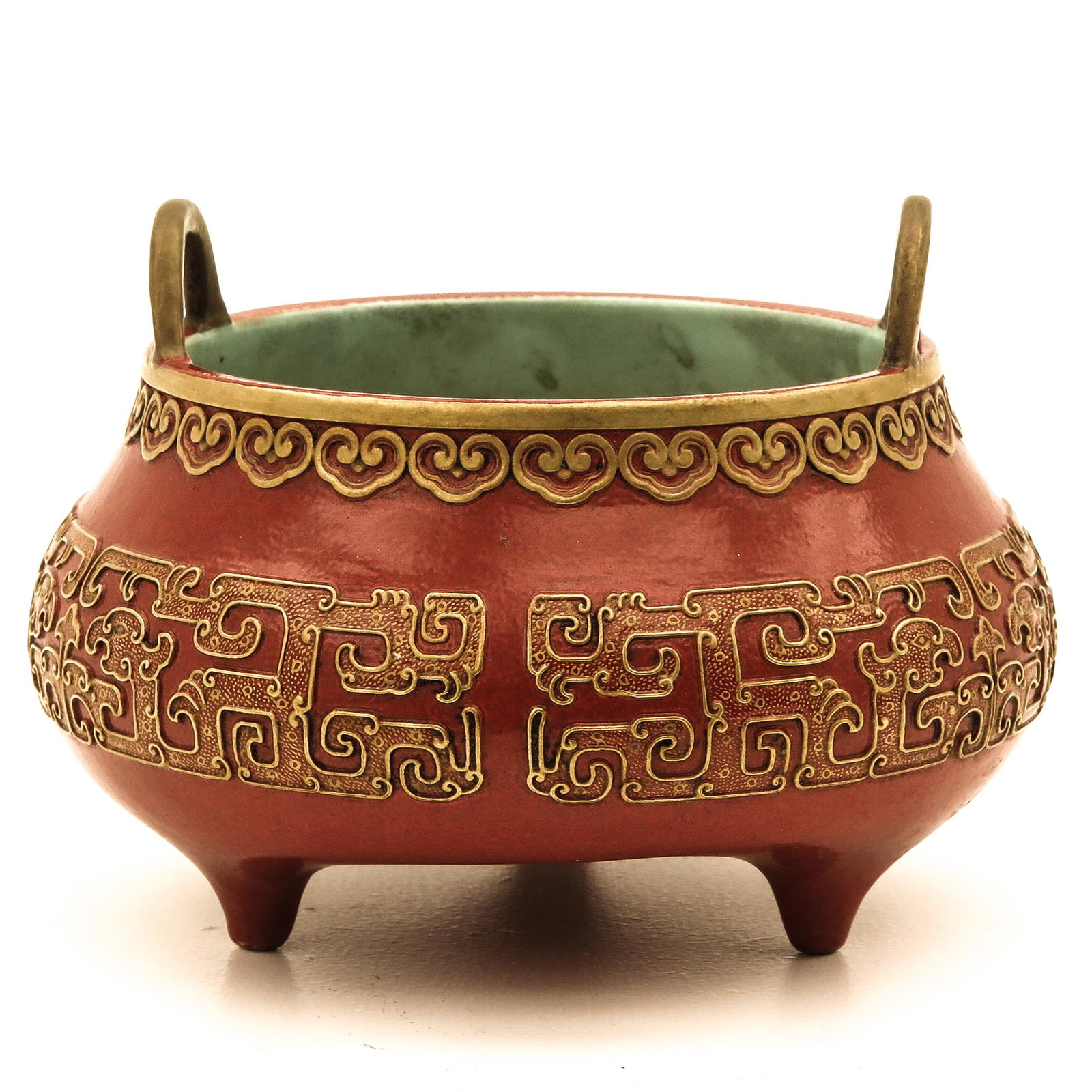 An Orange and Gilt Censer: Decorated with scroll work, Qianlong mark, 14 cm. in diameter.