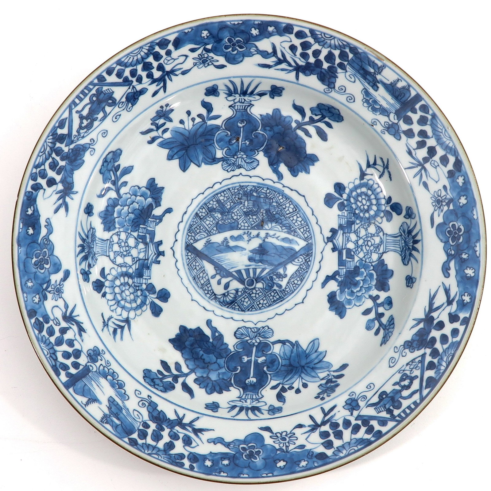 A Blue and White Charger: Decorated with flowers, convex center of plate depicting landscape, 33 cm. in diameter,