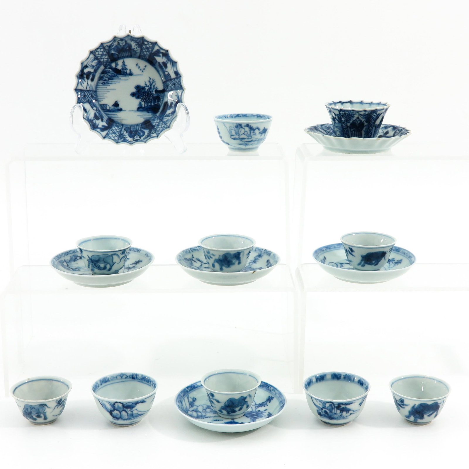 A Collection of 10 Cups and Saucers: Largest saucer is 10 cm. in diameter, chip and hairline.