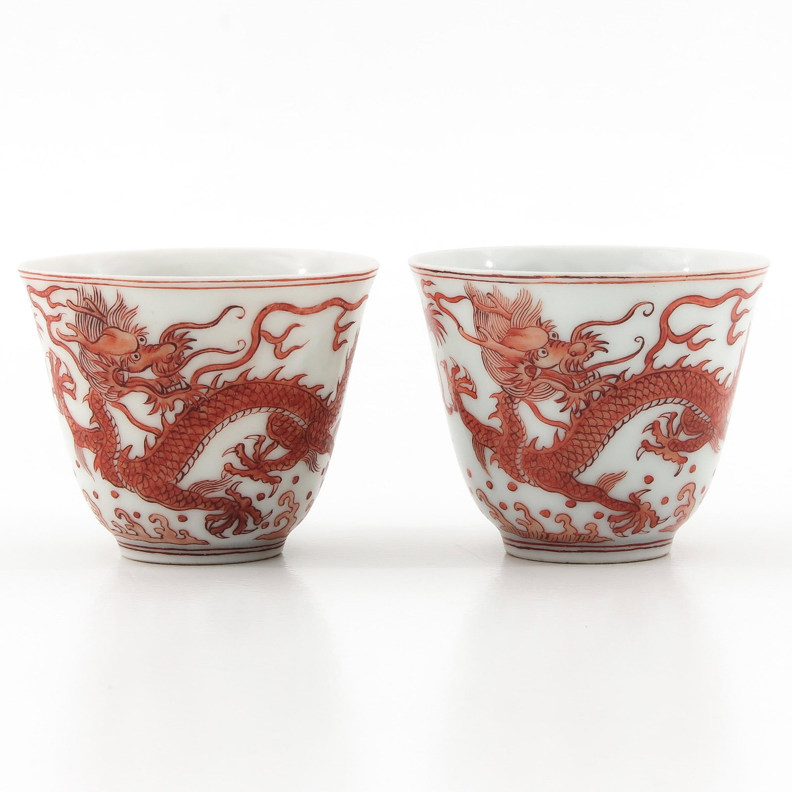 A Pair of Orange Decor Cups: Depicting dragons, Daoguang mark, 6 cm. in diameter.