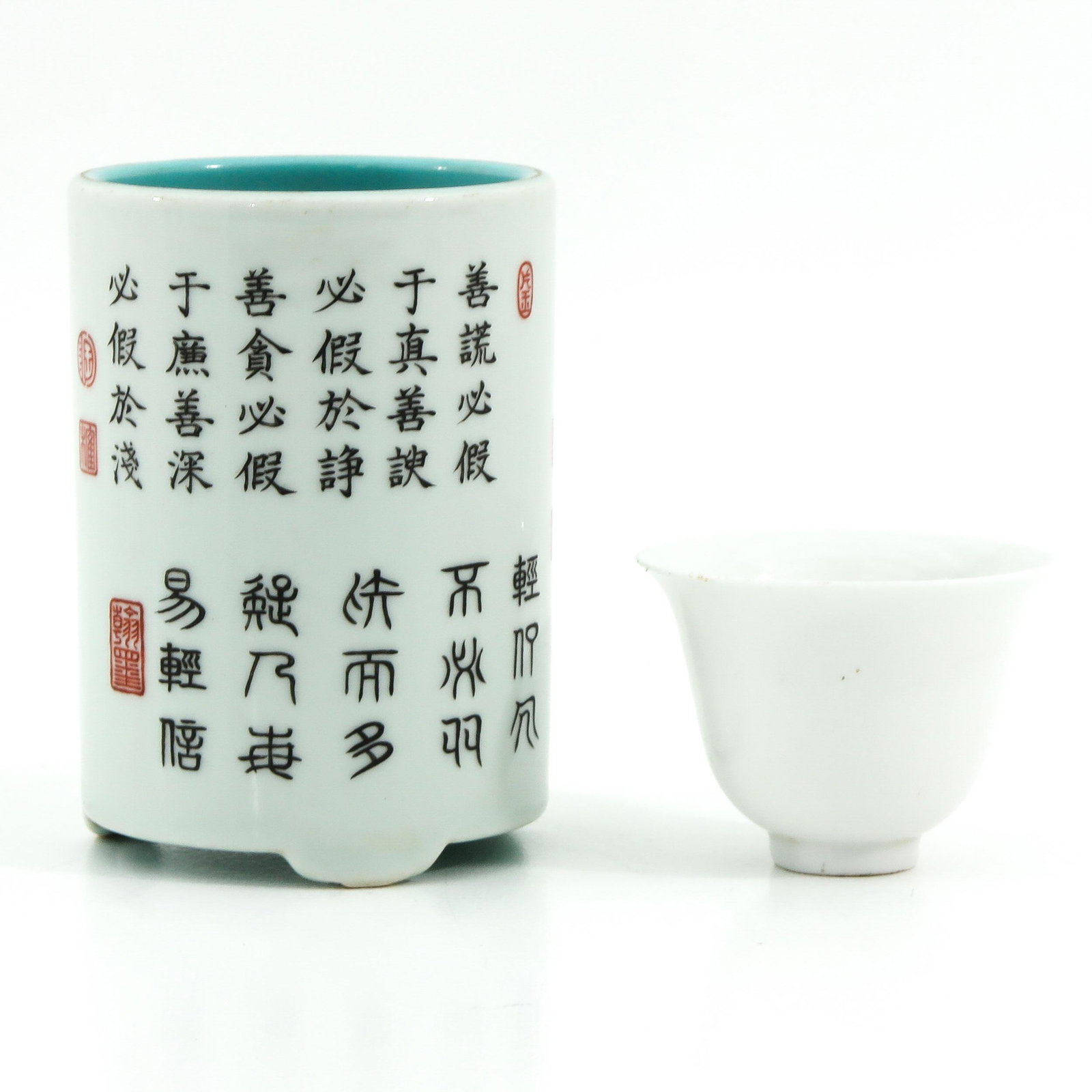 A Brush Pot and Cup: Brush pot decorated with Chinese text and seal marks with Qianlong mark 11 cm. tall, cup decorated with bird of paradise.
